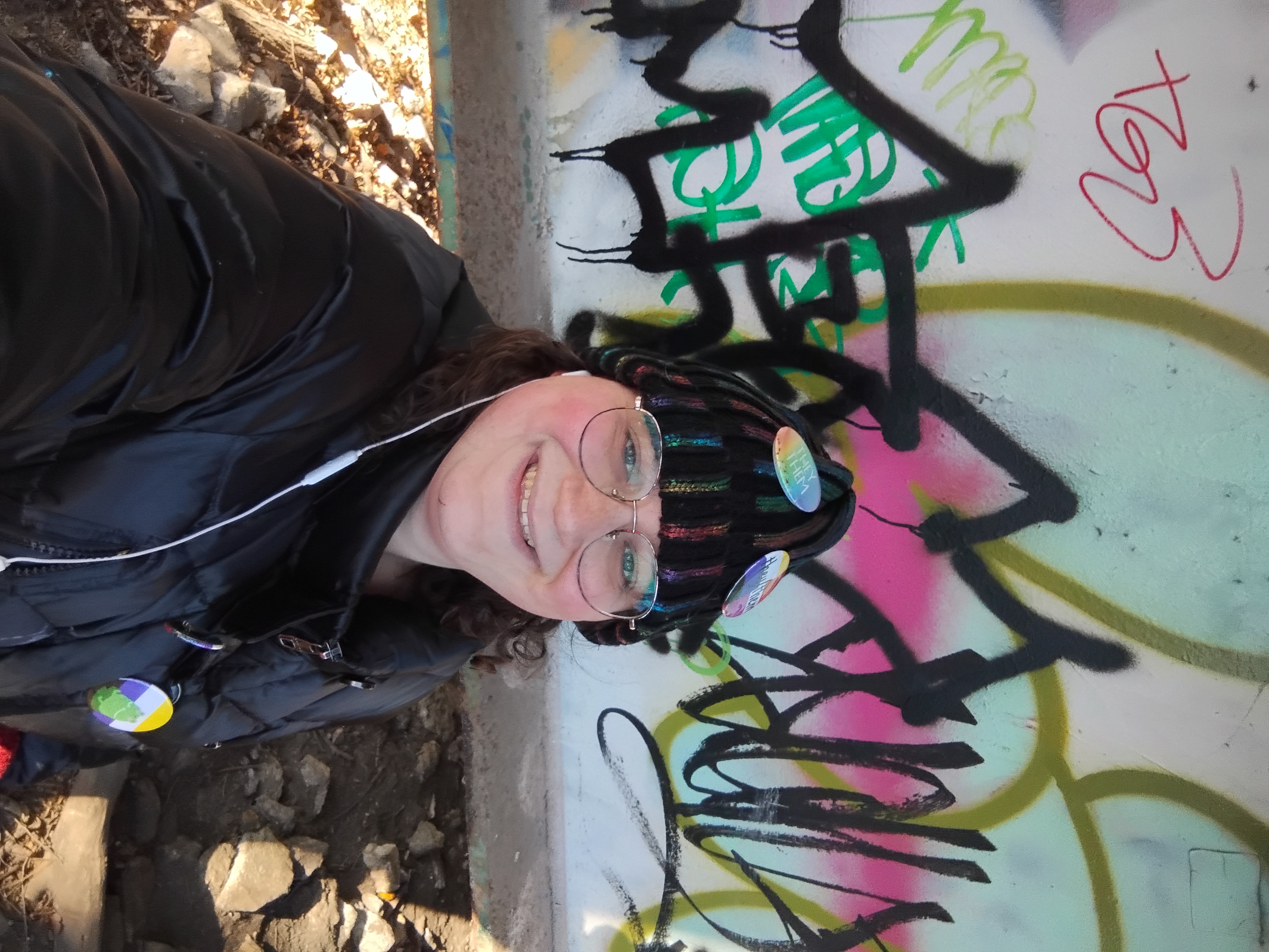 Me in front of a colorful array of graffiti.