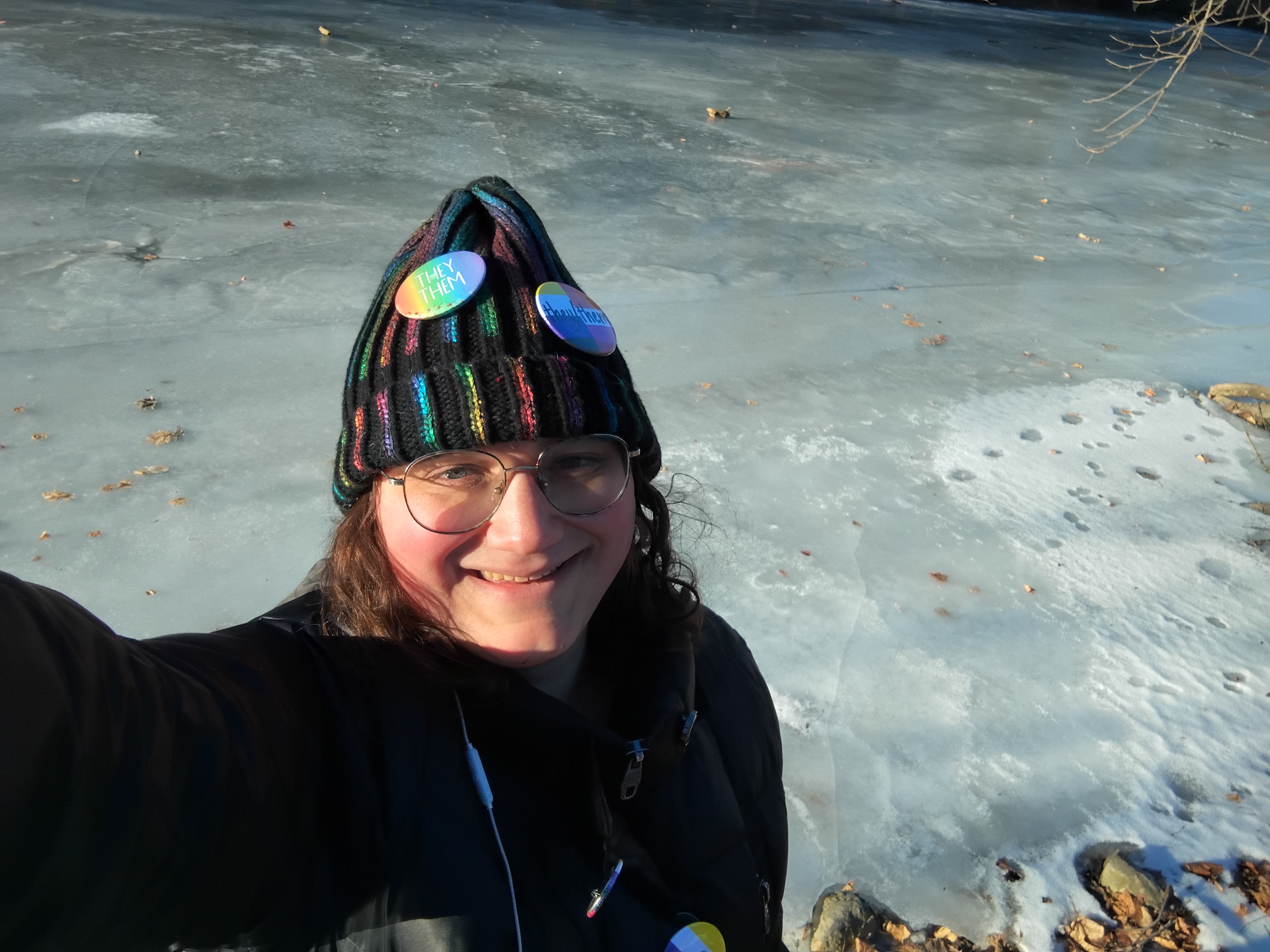 Hat on again, emphasizing the blue-green color of the frozen river.