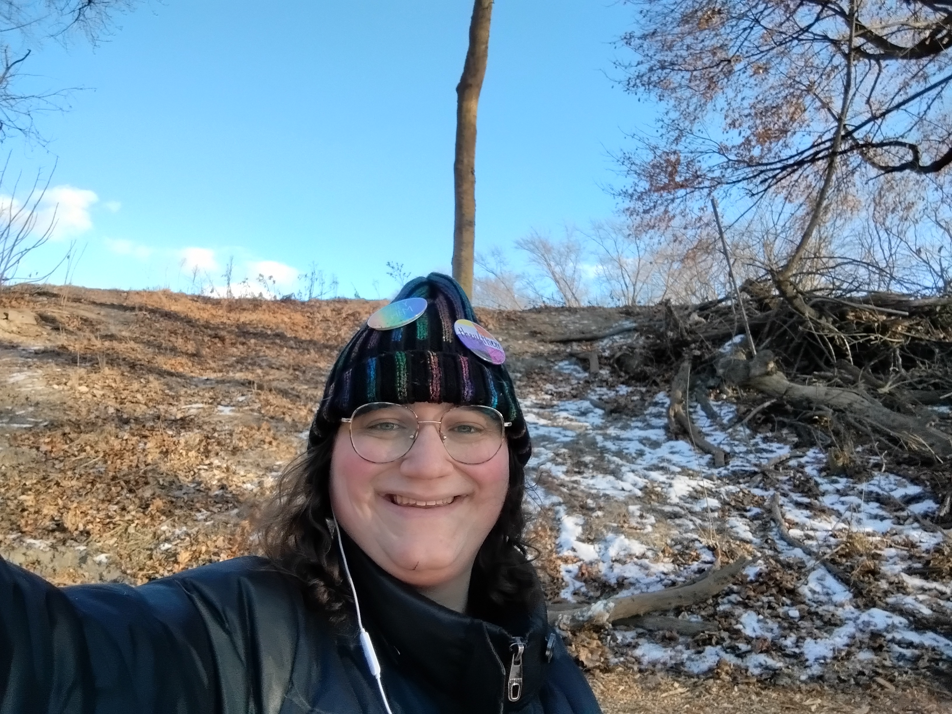 With the sky and a hillside behind me.