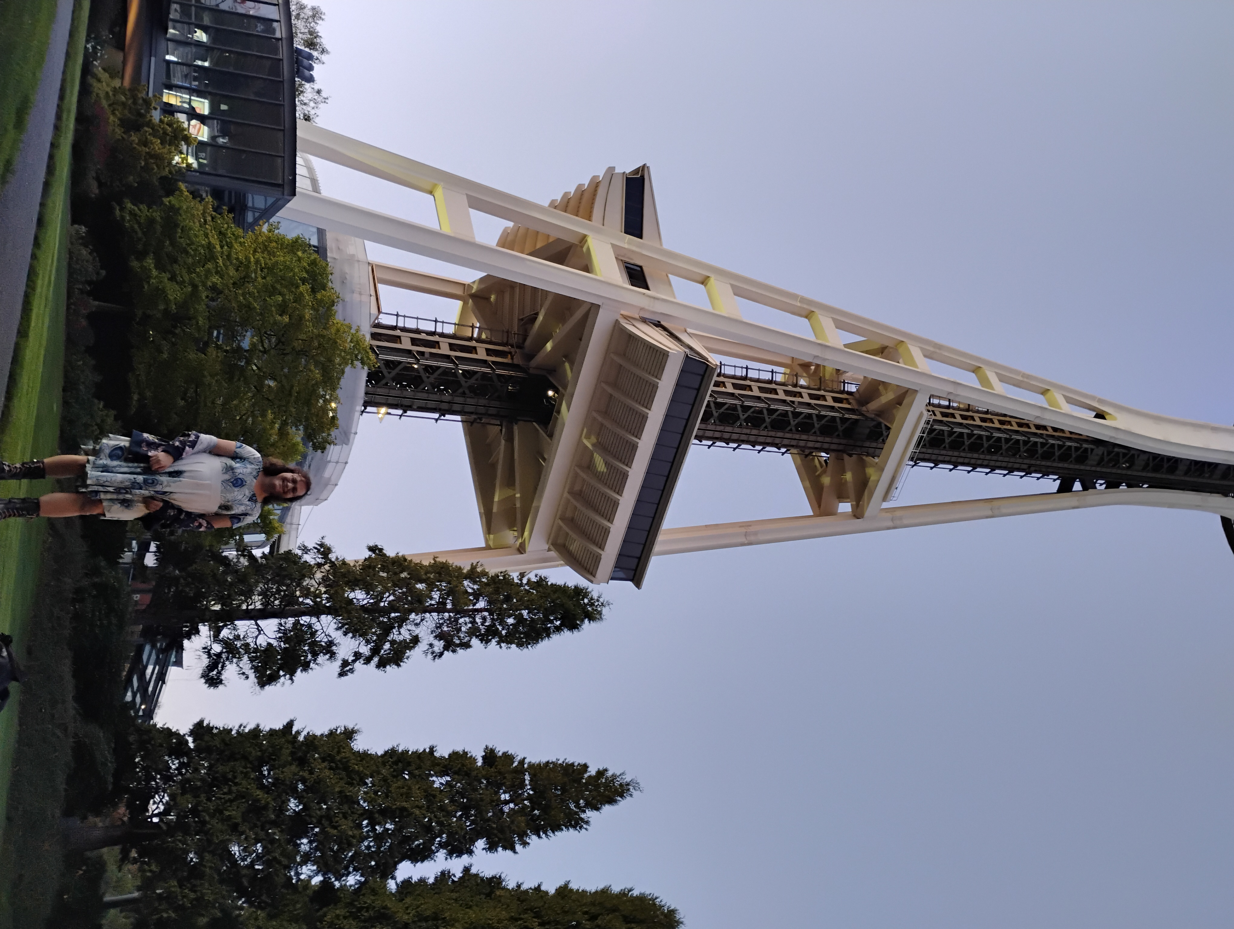 A more zoomed-out photo of me in the same peacock dress, in front of the Space Needle