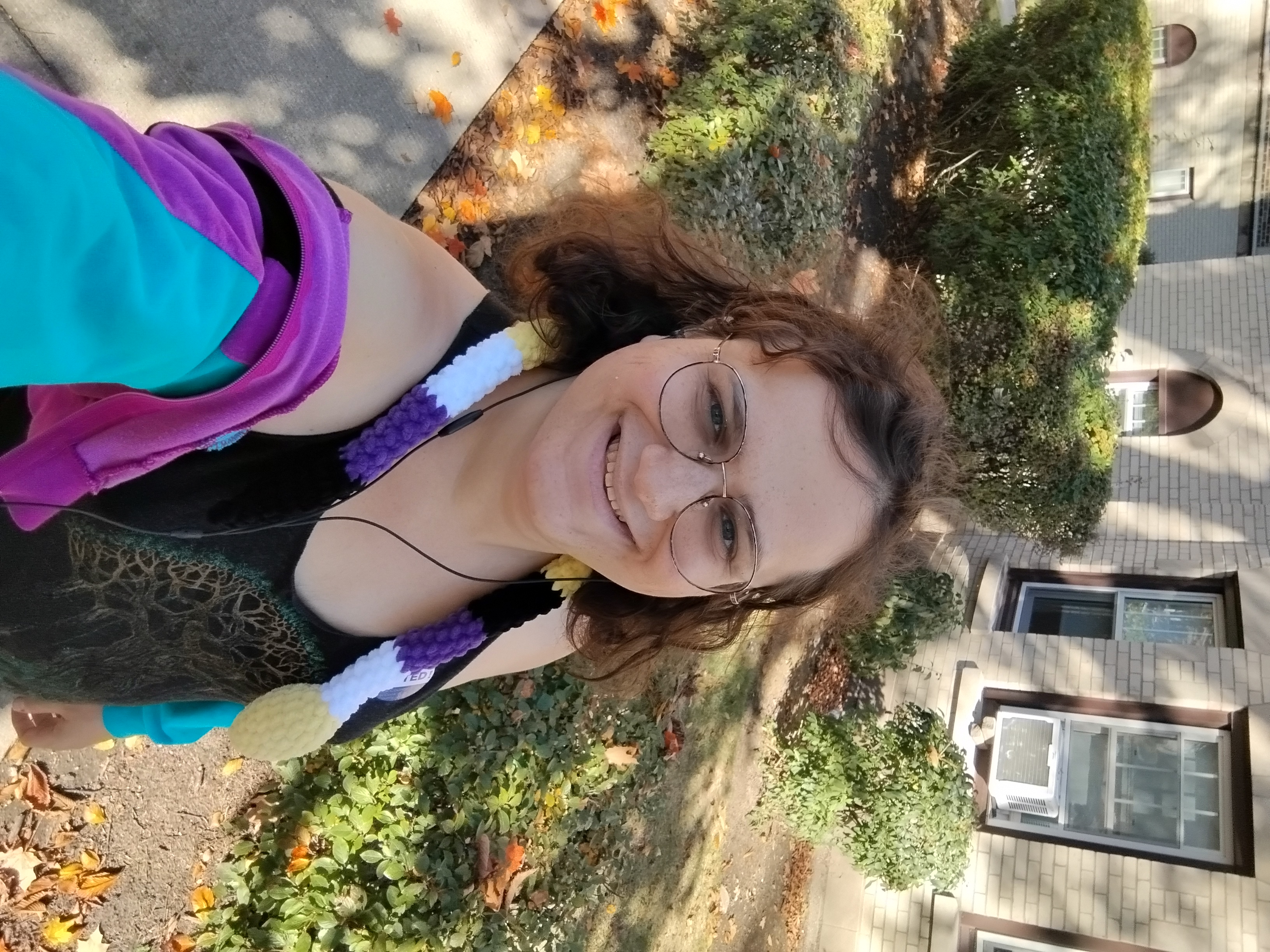 Me in a fractal-tree black tank top, and a purple-black-white-yellow snake and a blue-purple-black sweater down by my elbows