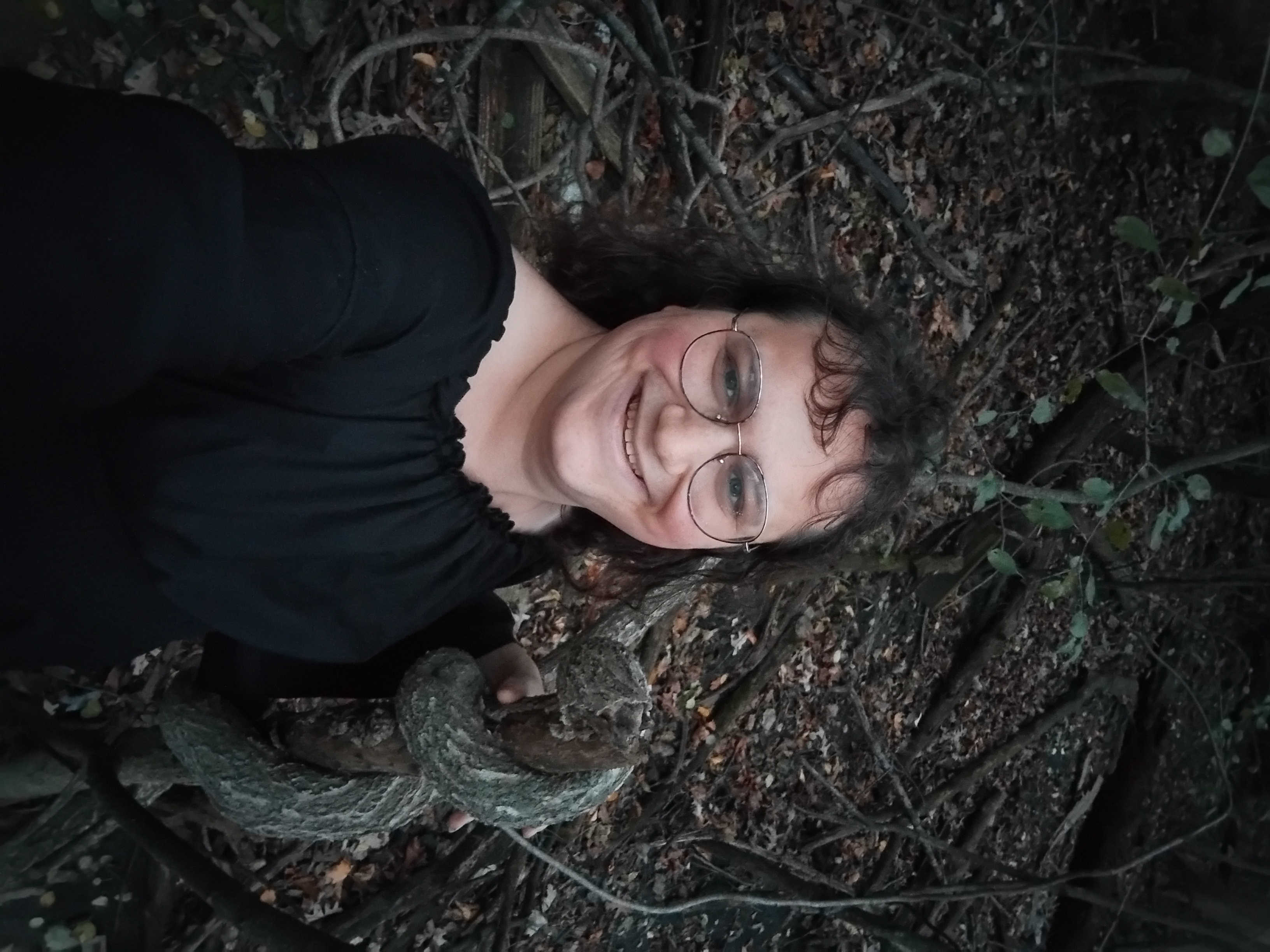 Me next to a tree that's grown in a spiral around another stick